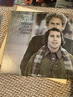 Simon & Garfunkel Bridge Over Troubled Water album cover showing two men with scarves and jackets, worn corners of cover.
