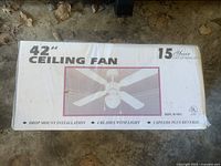 Front view of the sealed box showing brand specifications and design illustration of the 42-inch ceiling fan with four blades and light fixture.