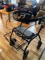 Side angled view of the Dolomite rollator, showing the cushioned seat, basket underneath, and front wheels.