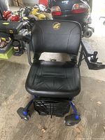 Front view of LiteRider Envy power wheelchair showing seat, foot platform and front casters