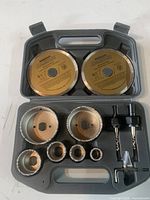 Overview of the full set in molded case including diamond blade discs, holesaws, drill arbors, and wrench.