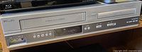 Front view of the Philips DVP 315OV DVD player and VCR combination showing front panel with disc tray, tape deck, buttons and AV input ports.