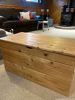 Full front view of the pine chest showing the rectangular shape and horizontal plank construction