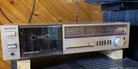 Full front view of vintage Sony cassette deck with cassette compartment, control buttons, and brand logo visible.