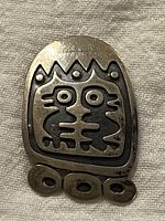 Front view of vintage sterling silver bird brooch with geometric stylized design and textured details.