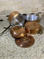 Overview of all copper cookware including saucepans, skillet, stockpot and lid