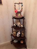 Full view of wooden corner shelving unit with decorative items on all shelves