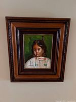 Close up of original painting showing the child and signature J. Roberts with wooden frame.