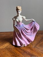 Front view of the Royal Doulton 'Rachel' figurine showing delicate pink and purple gown, fan, and detailed face.