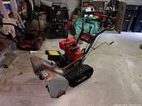 Overall front-left view of snowblower in garage