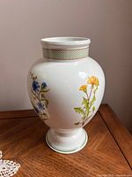 Front and side views of Villeroy & Boch Eden tulip vase showing floral patterns and lattice neck design.