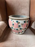 Front and side views of the vintage ceramic planter showing the detailed floral pattern and overall shape.