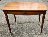 Front view of the 1960s Knechtel wooden side table showing tapered legs and drawer