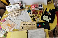 Overview of vintage magic props including decks of cards, dice, rope, coins, Climax Egg Bag, and instructional booklets.