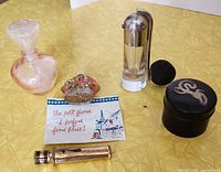 Overview photo showing all vintage perfume-related items on a yellow surface.