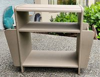 Front view showing two open shelves between side compartments with curved cut-out design.