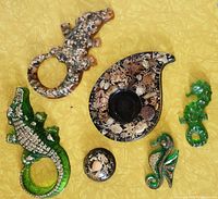 Top view of the Lucite desk set with embedded seashells and five animal figurines including seahorses and alligators arranged on a yellow surface