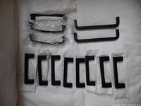 Photo showing all cabinet pulls laid out on cloth, including various sizes and some still in packaging.