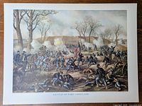 Full view of the Battle of Fort Donelson print depicting the battlefield scene with Union soldiers advancing and artillery firing, with trees and hills in the background.
