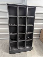 Front view of the tall black CD curio shelf showing all compartments empty.