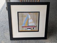 Frontal view of framed sailboat art print showing full image and frame condition