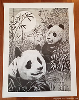 Full view of the black and white panda bears poster with bamboo and moon background.