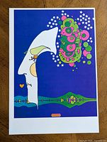 Full view of the colorful Peter Max psychedelic pop art poster featuring abstract shapes and stars on blue background.