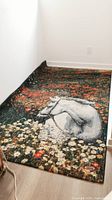 Full view of the area rug laid along a hallway showing the horse and flower design.