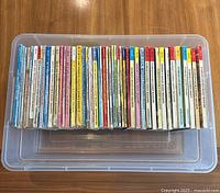 Top-down photo showing a large plastic container filled with a stack of 36 Archie comics digests laid vertically showing the thickness and condition of the comics.