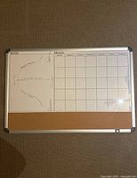 Full view of the calendar whiteboard showing handwritten notes and scratch marks.