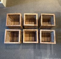 Top view of six square woven baskets arranged in two rows of three, showing open tops and interior weave.