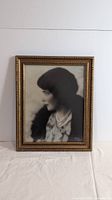 Front view of framed vintage black and white photograph showing woman's profile and frame detail.