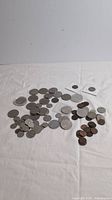Overview of full coin assortment laid out on white cloth