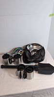 Full set laid out, showing mugs, shovel, ropes, and mesh bags