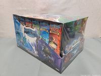 Box of six Lightseekers Awakening trading card game starter decks in original sealed packaging, showing colorful artwork and product branding.