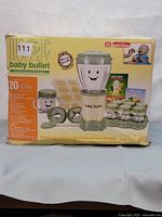 Front of the Baby Bullet box showing the blending cup with base, jars, and 20 baby food recipe highlights.
