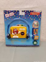 Front view of sealed M&M's AM/FM radio cassette player Walkman with candy dispenser in original packaging.