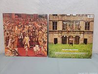 Photo showing front and back of the Hot Rocks '64-'71 album covers with album artwork and text.