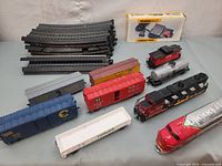 Photo of multiple black plastic train tracks curved and straight.