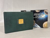 Exterior view of green folio case and original space-themed box