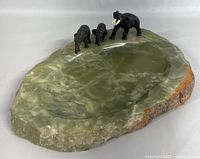 Full view of the onyx ashtray with three bronze elephant figurines positioned on the edge, showing polished surface and rough side edges.