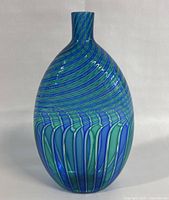 Front view of the Murano glass vase showing the swirling blue and green stripes