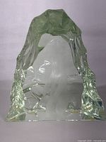 Front view of clear sculpted glass block with etched standing polar bear inside showing natural ice-like textured edges.