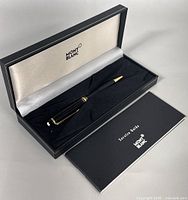 Open presentation case showing pen and service guide booklet