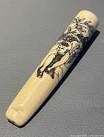 Front side of the pipe showing hand-decorated Asian figure and bamboo design.