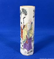 Front view showing hand painted elderly men in colorful robes with natural setting.