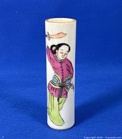 Front view of the porcelain vase showing the hand painted woman figure holding a sword.