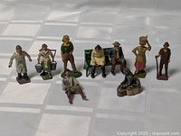 Group shot of all ten Britains lead town figures and bench