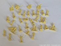 Group shot of all yellow HO scale Airfix airforce figures and accessories