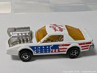 Left front view of Majorette car showing engine and flag graphics